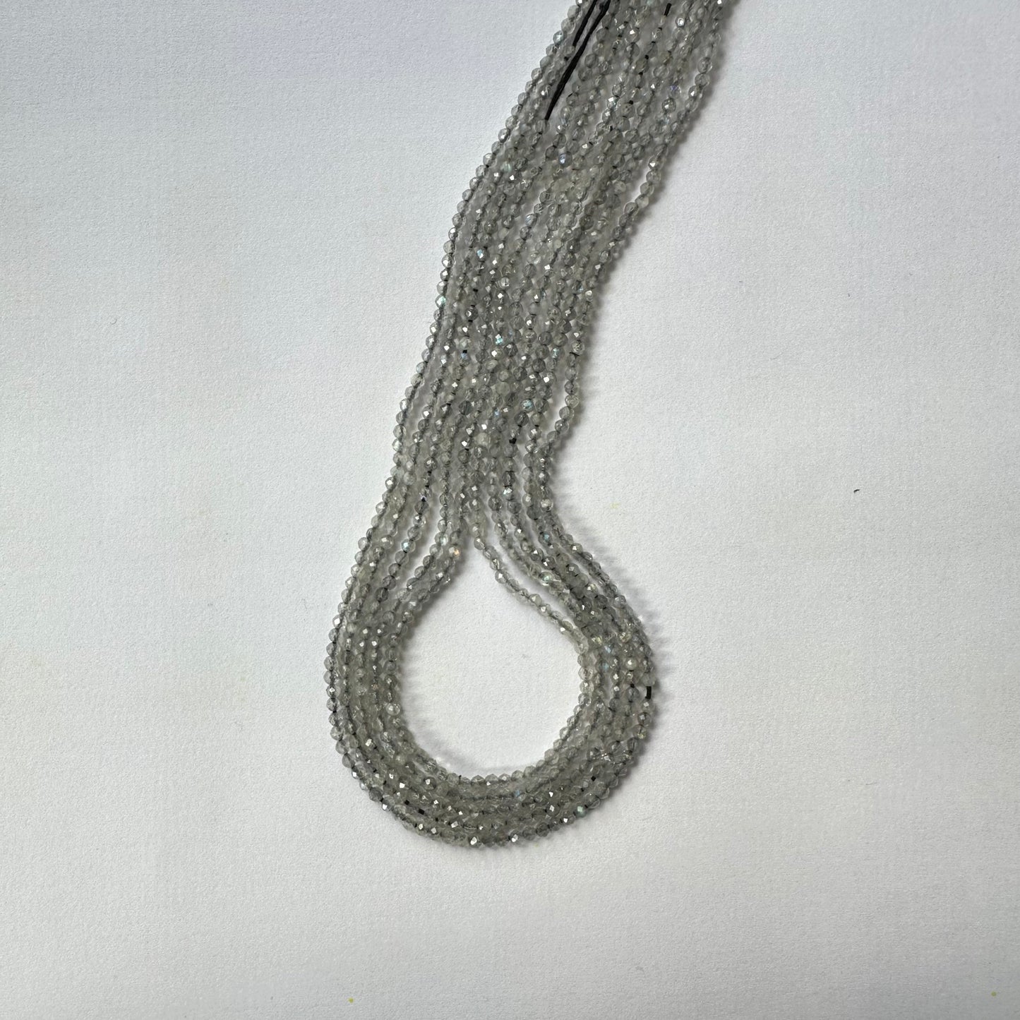 Strands of 2.2mm Labradorite faceted rondelle beads display captivating light reflections and polished finish.