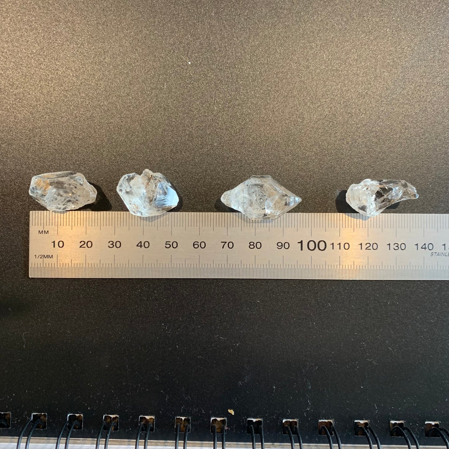 A ruler measures the Herkimer Diamond rough undrilled 21mm gemstone, ensuring precise sizing.