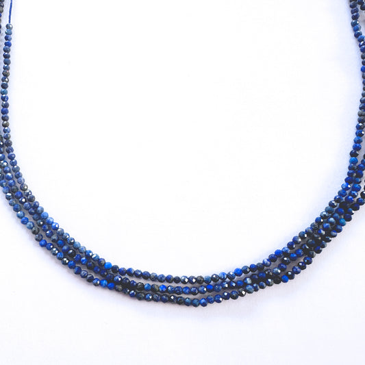 Close-up of Lapis Lazuli rondelle beads showing rich navy tones and precision faceting.