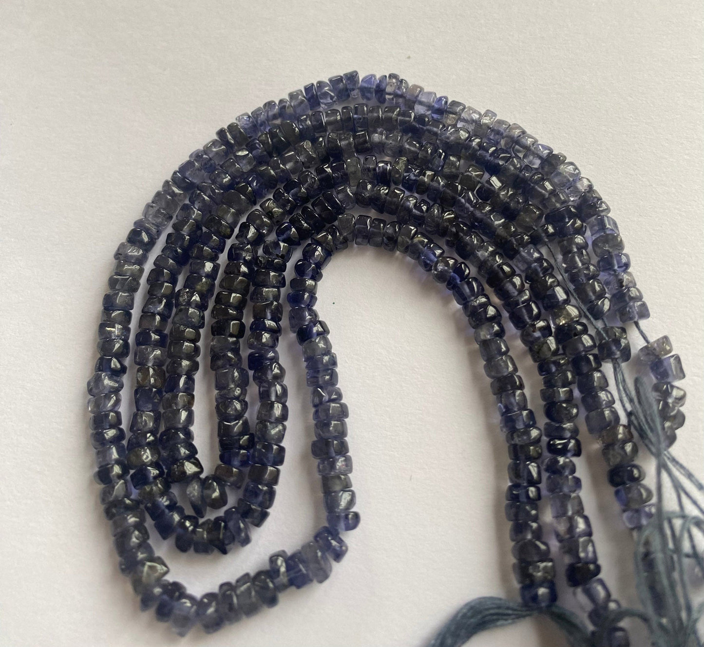 High-quality iolite beads, smooth wheel shape, 5 to 5mm, featuring a lustrous finish and vibrant colour, perfect for crafting unique designs