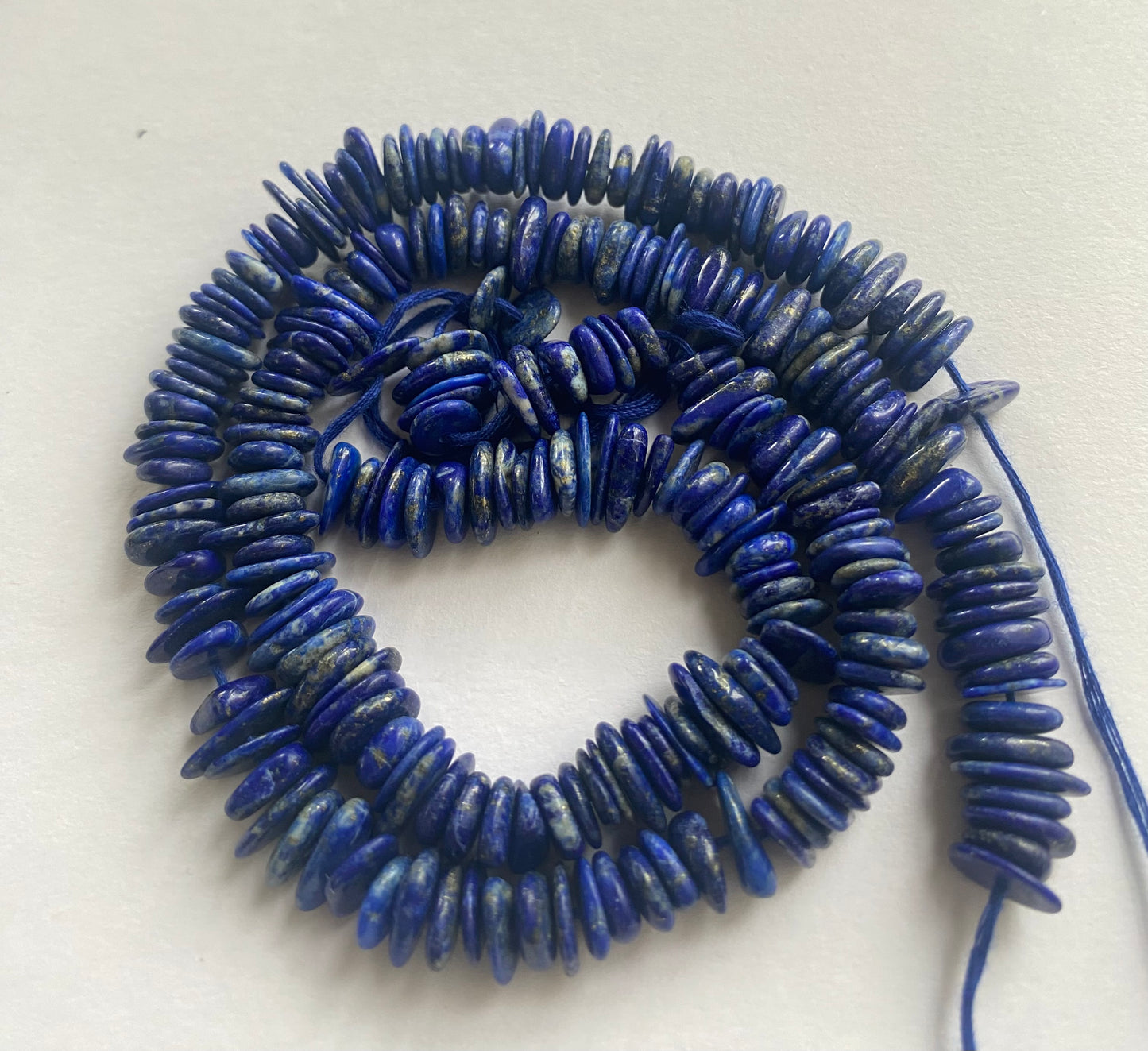 Featuring smooth Lapis Heishi Smooth beads, showcasing a beautiful blue hue.