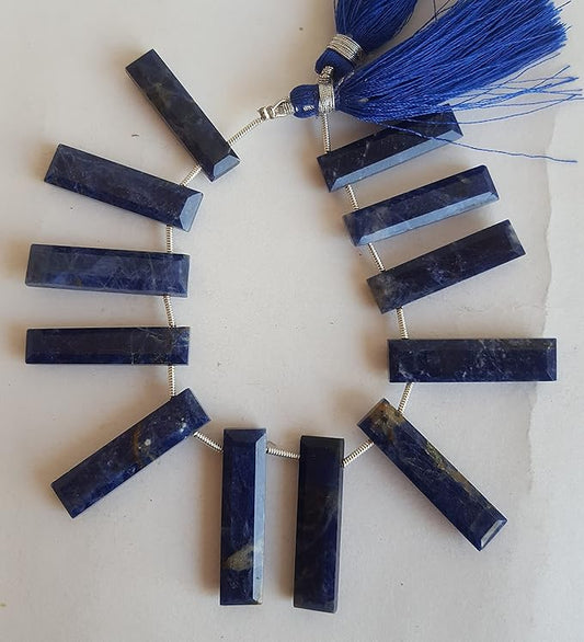 A vibrant blue gemstone bead strand, adorned with lapis lazuli faceted briolette gemstones.