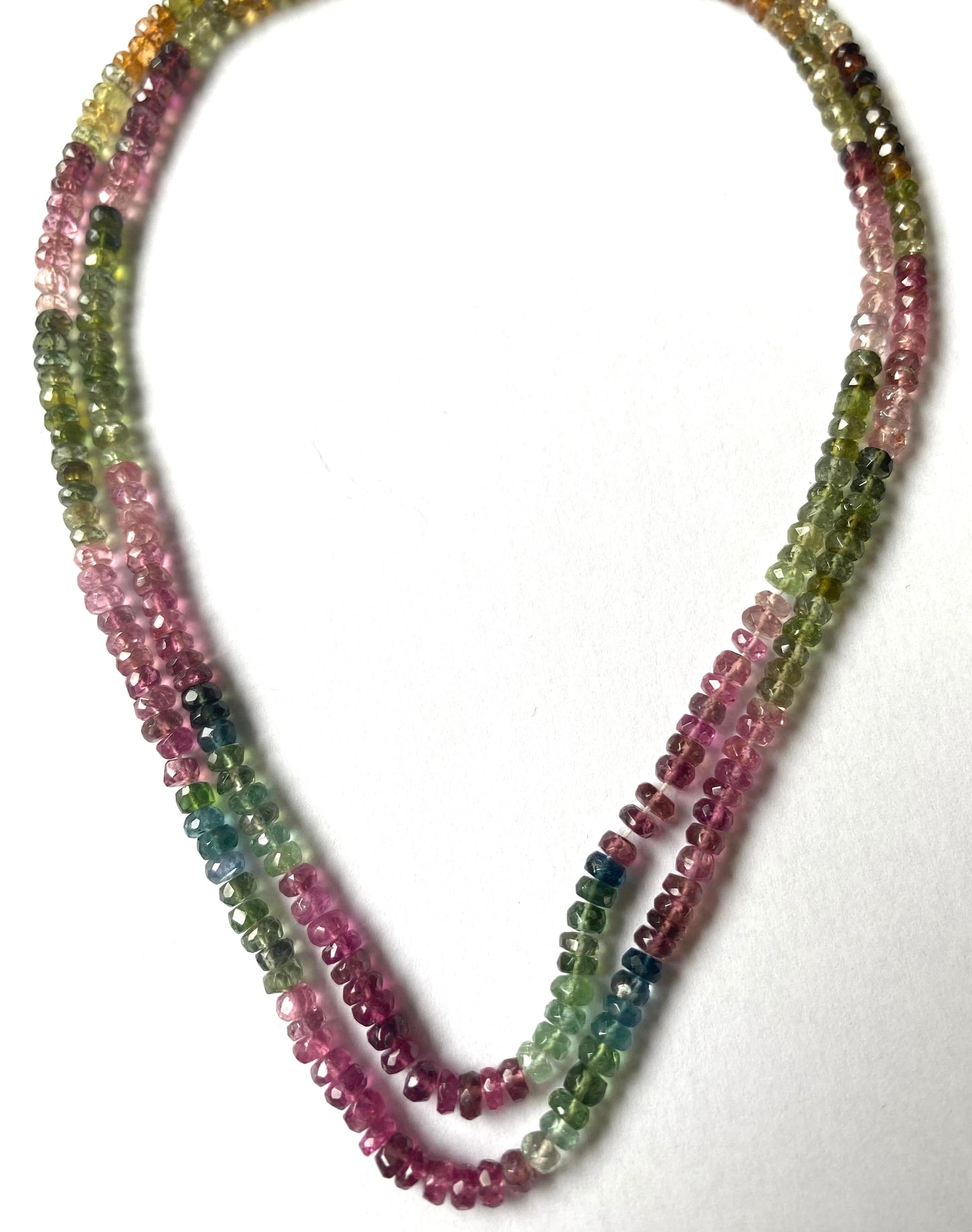 Multi-strands of micro-cut, 3.5mm multicoloured tourmaline beads, showcasing vibrant hues and intricate design.