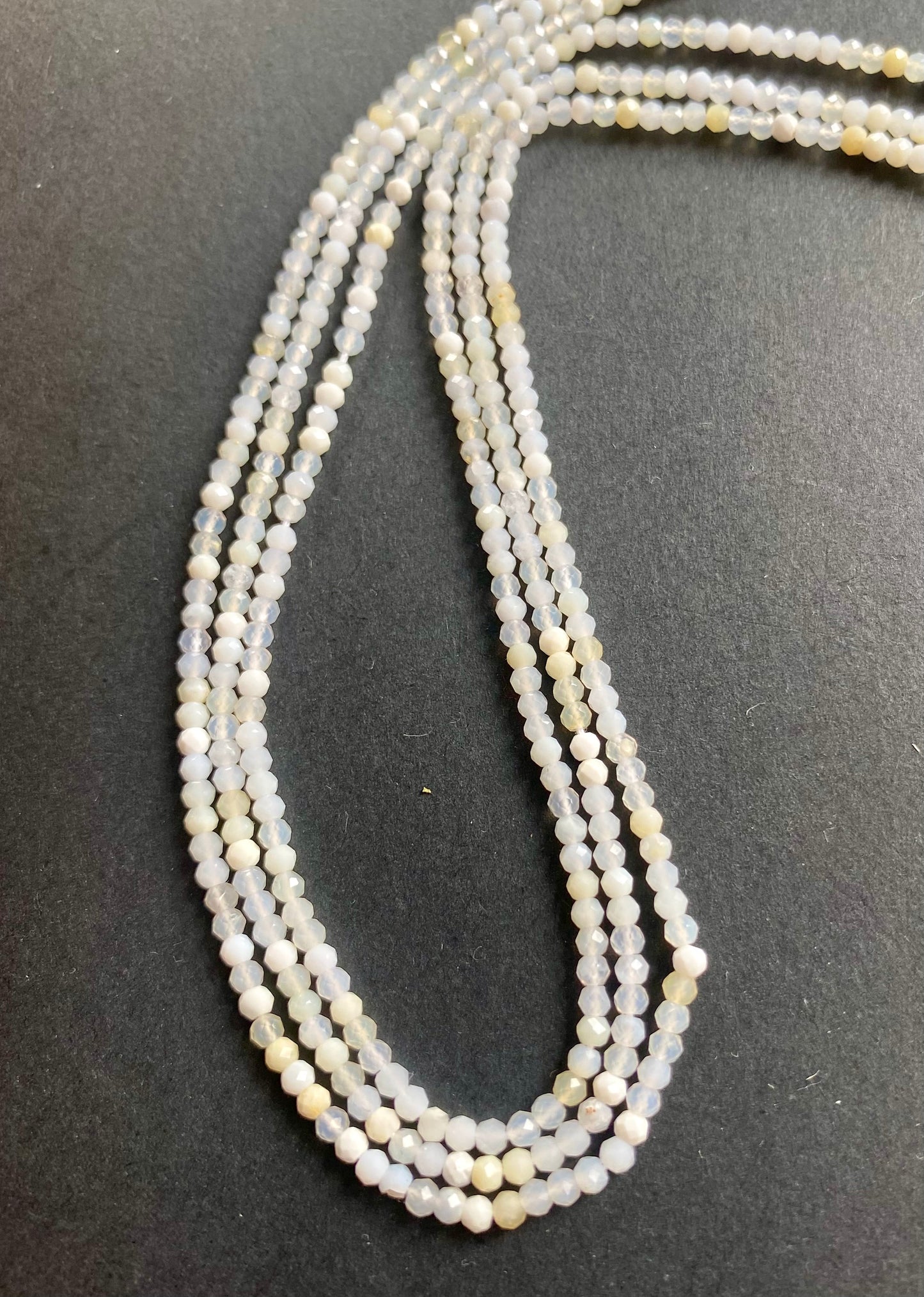 Elegant strands adorned with 2.6-2.7mm micro-faceted opal rondelle beads, showcasing a sleek design.