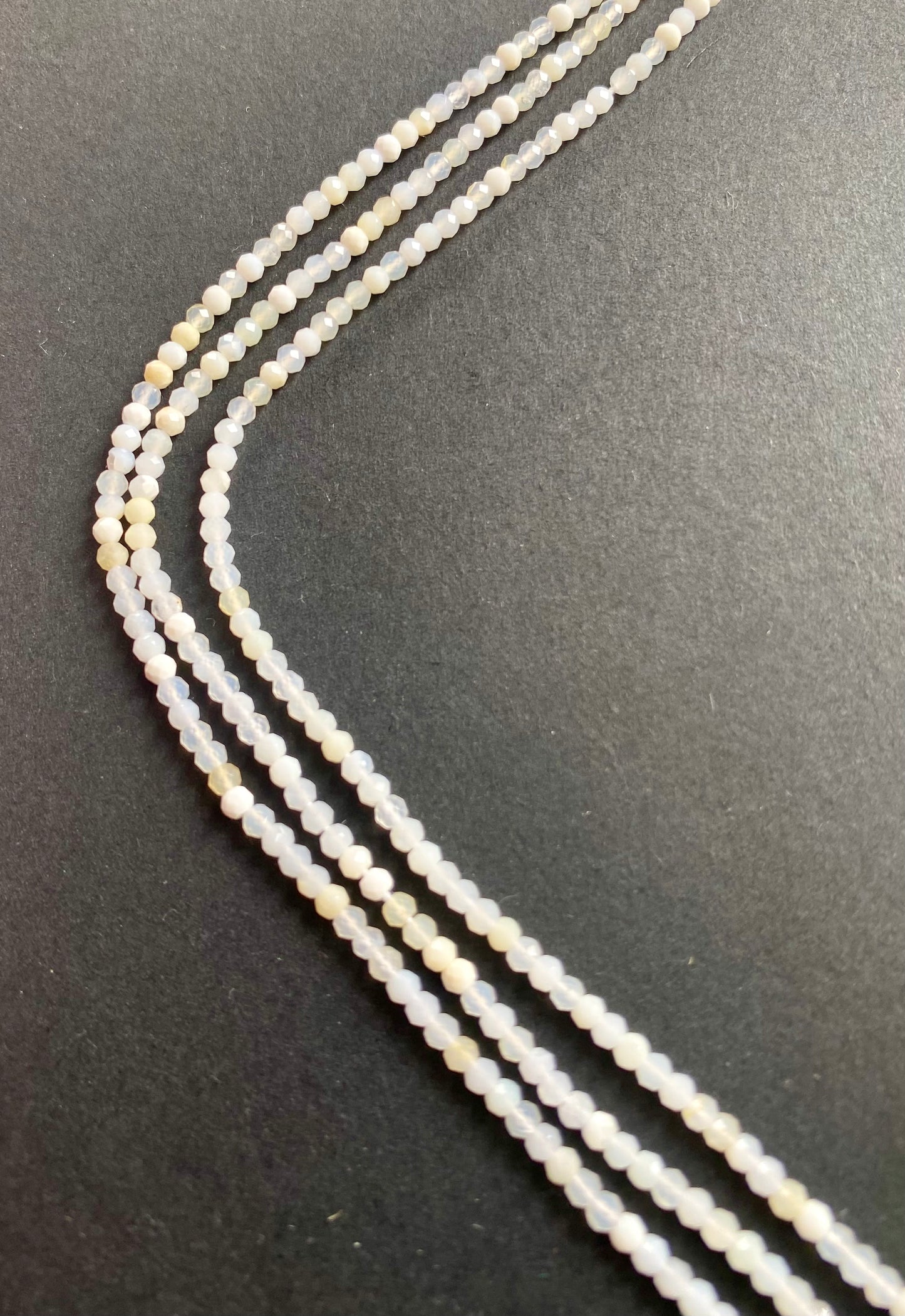 Vibrant strands featuring 2.6-2.7mm micro-faceted opal beads in various colours, highlighting their beauty.