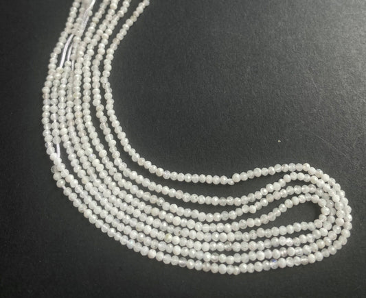 A vibrant strand of 2.1mm white moonstone faceted rondelle beads, highlighting their natural elegance and charm.