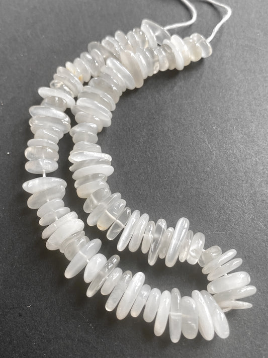 Close-up of 8-12mm Moonstone gemstone chips showcasing their soft translucence and polish.