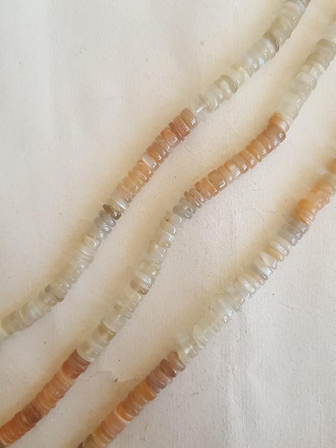 Close-up of a gemstone bead strand highlighting moonstone smooth wheel gemstones.