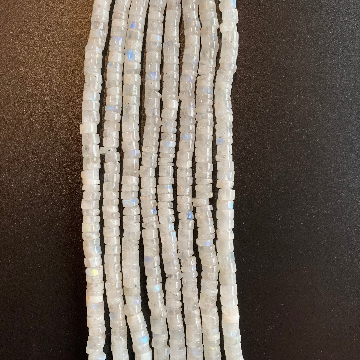 Close-up of Moonstone smooth wheel beads, highlighting their soft glow and natural translucency.