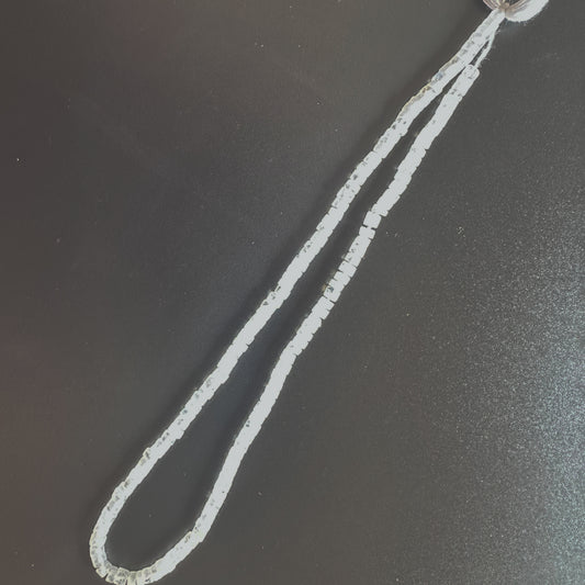 Moonstone beads arranged in a neat strand with consistent shape and radiant glow.