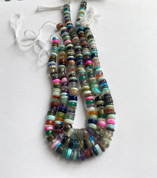 A close-up of Multi Disco beads with polished edges and dynamic light reflection.