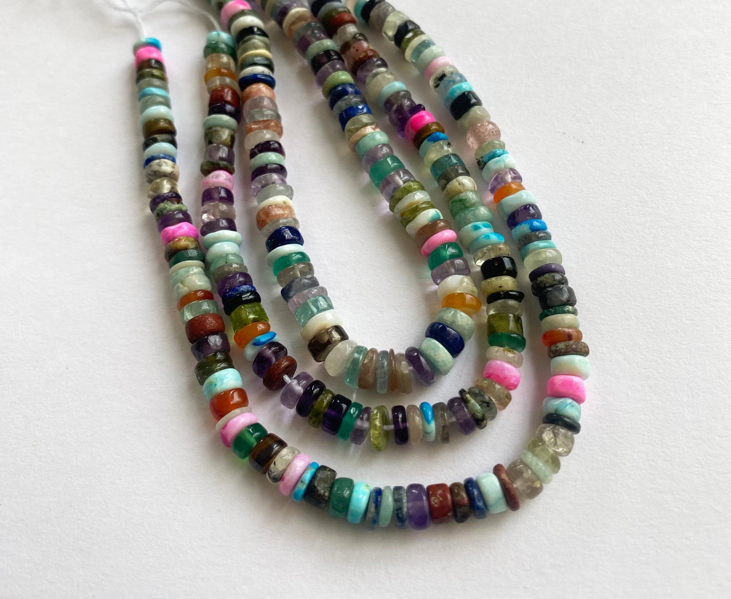 Vibrant, smooth wheel-shaped beads showcasing refined shine and sleek texture.