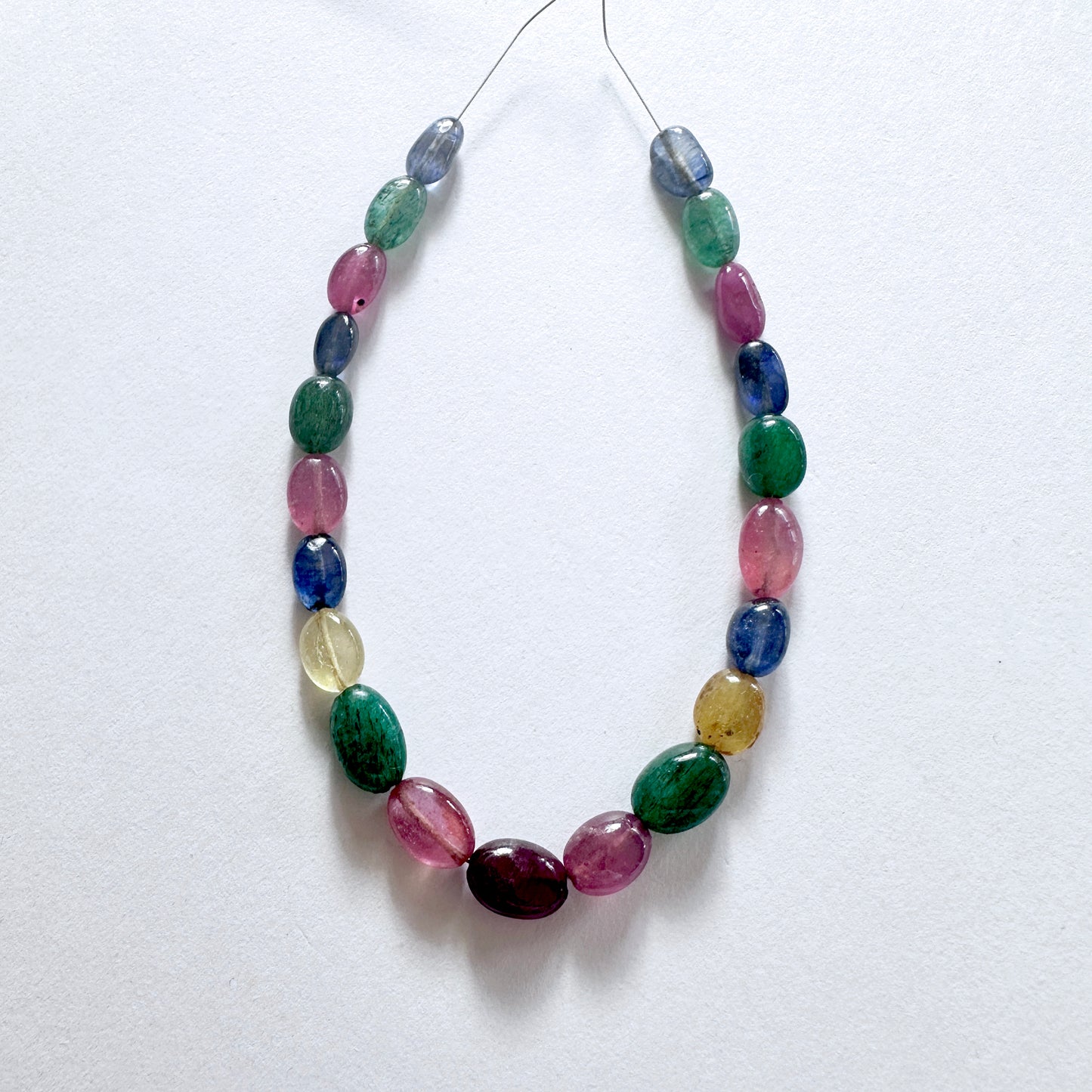 Premium multi stone oval beads arranged in a 21-piece set with consistent sizing and radiant shine.