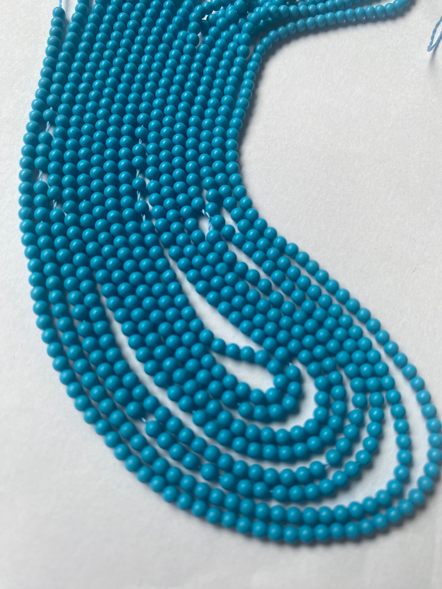 Howlite Turquoise Smooth Round beads, 2.3mm size, on a strand, ideal for jewellery making.