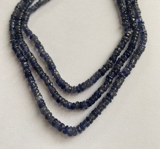 Elegant iolite gemstone beads with a smooth wheel cut, 5 to 5mm, showcasing rich blue hues and exceptional clarity for jewellery making