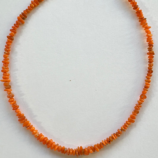Opal gemstone chips with soft orange hues and polished surface arranged on a 40cm strand.