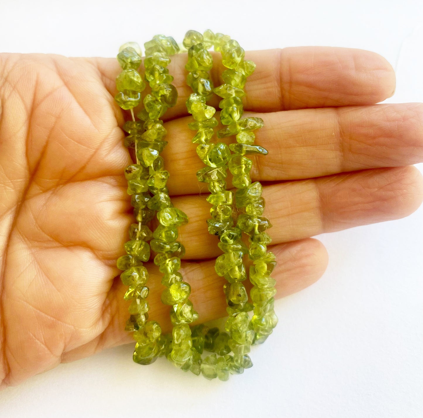 High-quality Peridot chips 5 to 8mm with a lustrous finish and vivid green tones perfect for intricate jewellery creations.