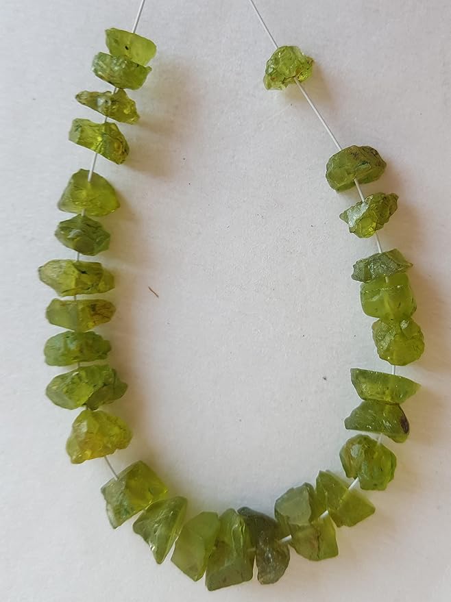 Elegant strand of rough natural peridot gemstone, beads sized 7mm to 8.5mm, highlighting their natural beauty and vibrant colour.