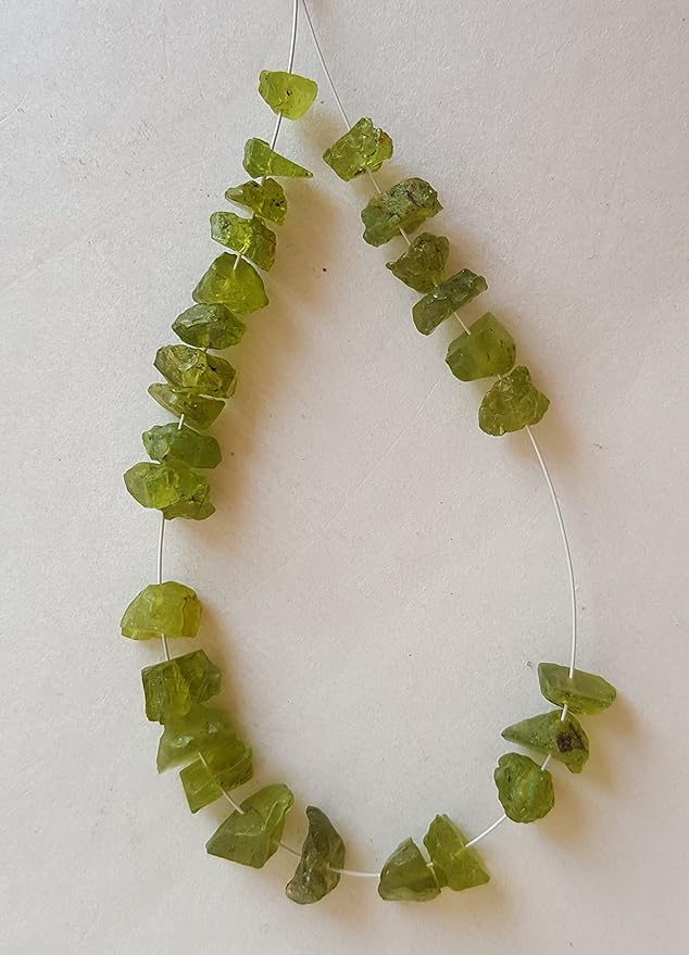 A strand crafted from rough green natural peridot gemstone, with beads sized between 7mm and 8.5mm, radiating warmth and elegance.