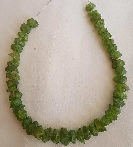 Strands featuring peridot gemstones, each bead showcasing a rough, natural texture.