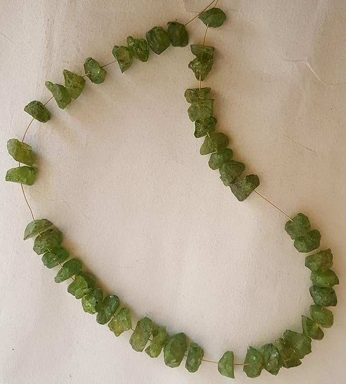Strand featuring rough peridot beads, each measuring 7-9mm, showcasing a vibrant green colour.