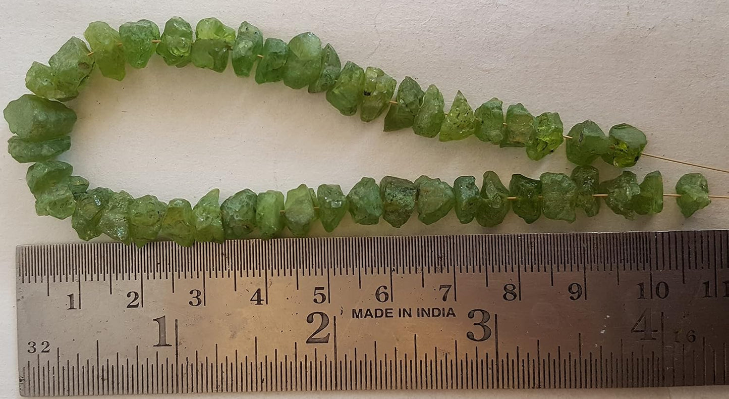 A ruler beside a peridot natural gemstone bead, measuring 7mm-to-9mm in diameter.