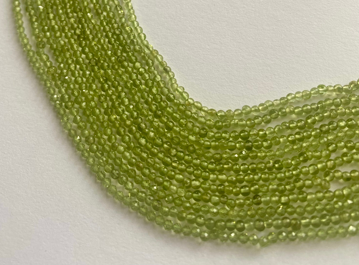Strand featuring smooth rondelle peridot gemstones, ranging from 2.5mm-to-2.8mm , in a stunning green hue.