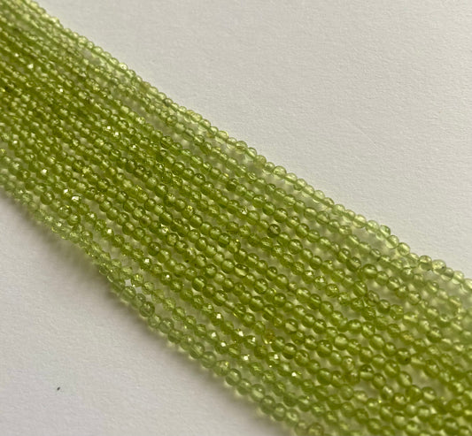 Elegant strand adorned with 2.5mm-to-2.7mm smooth Round peridot stones, showcasing a rich green colour.