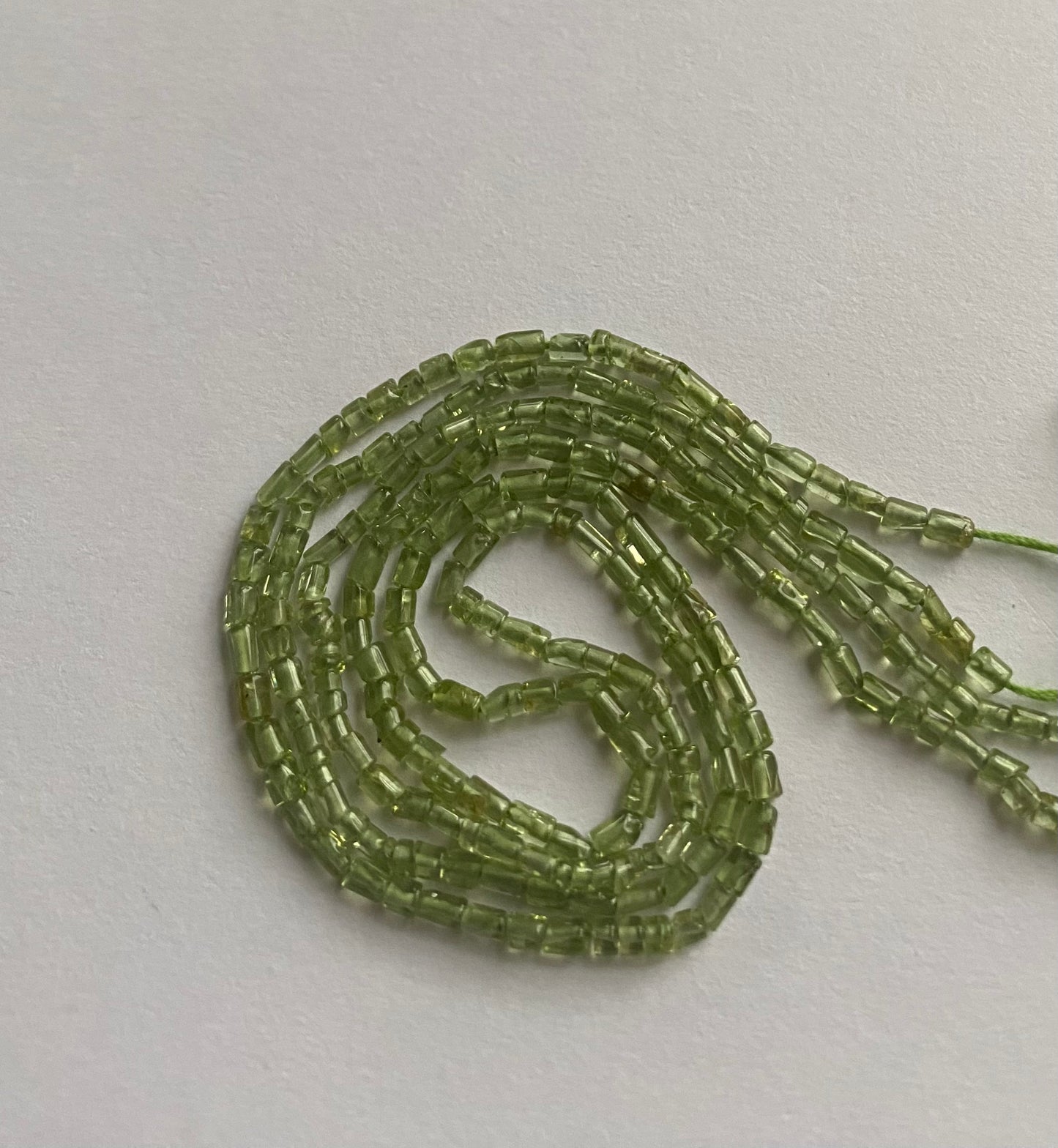 Beautiful green peridot stones,tube-shaped measuring between 2mm and 2.2mm.