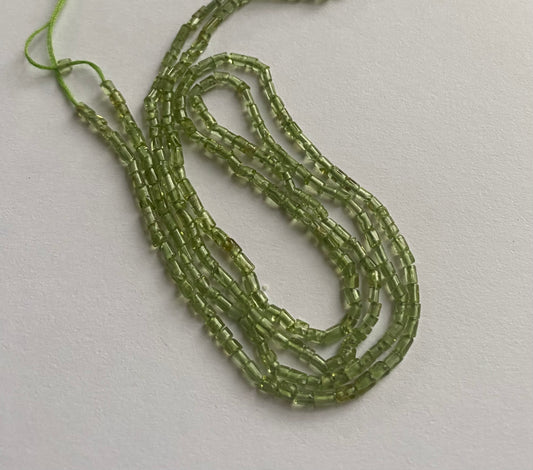 Elegant strand adorned with 5mm to 8mm peridot tube shaped stones, showcasing a rich green colour.