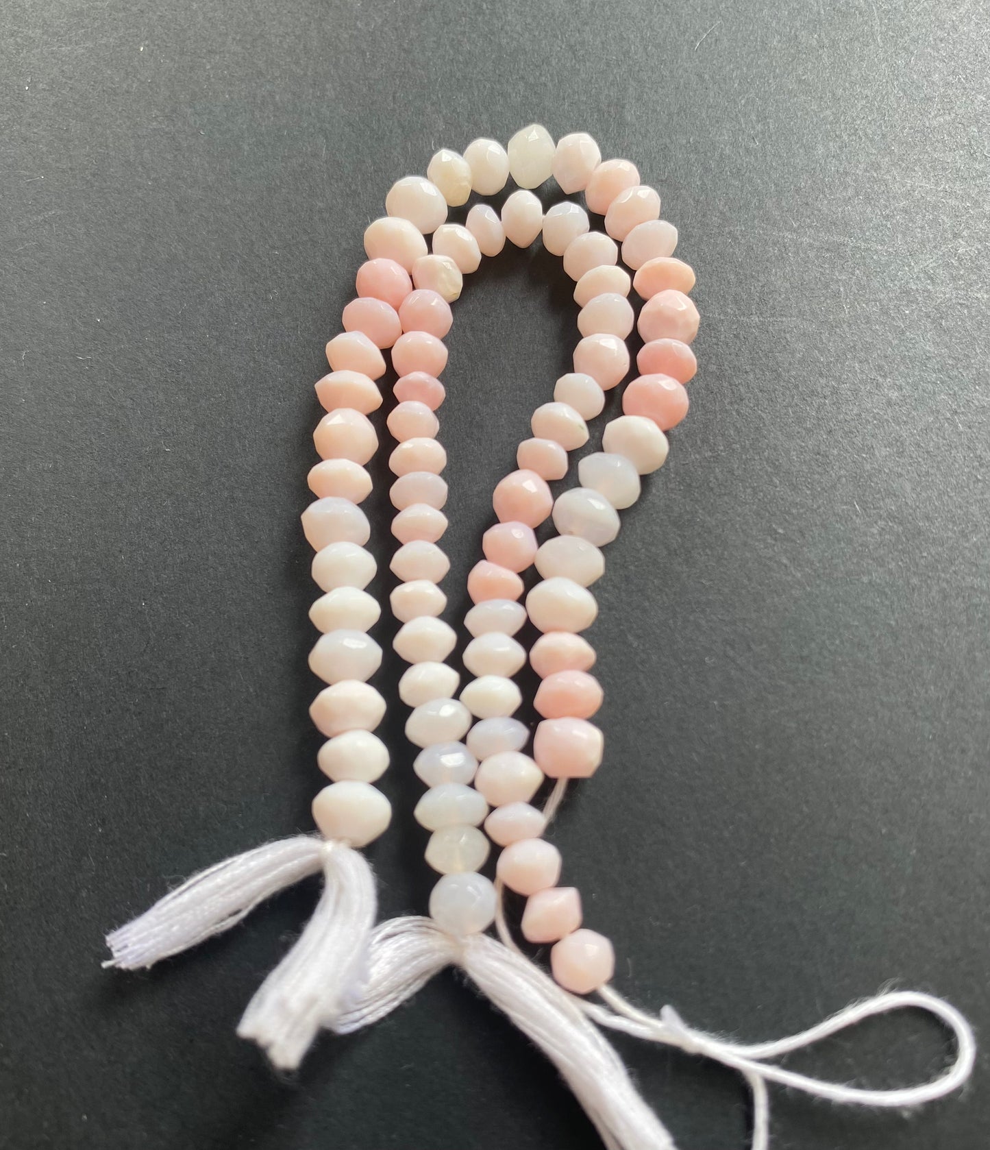 Featuring faceted rondelle opal beads, 6mm or 7mm in size, showcasing a beautiful pink hue.