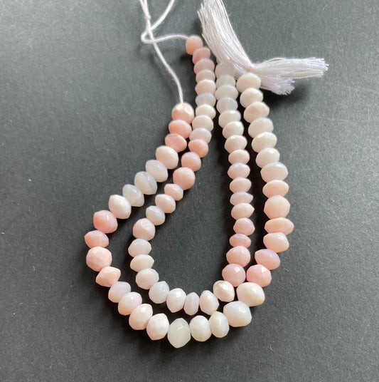 Elegant gemstone strand adorned with 6mm or 7mm faceted rondelle pink opal beads, highlighting the beauty of the opals gemstone.