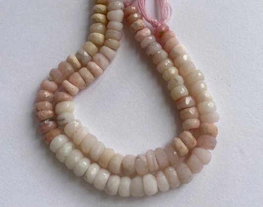 Close-up of 6-6.5mm Pink Shaded Opal beads displaying delicate faceted cuts.