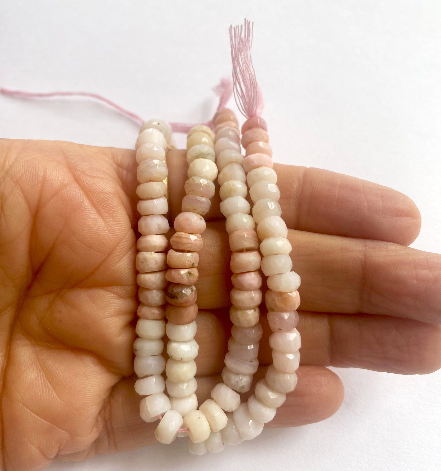 16cm strand of Pink Shaded Opal rondelle beads with shimmering tones and precision-cut facets.