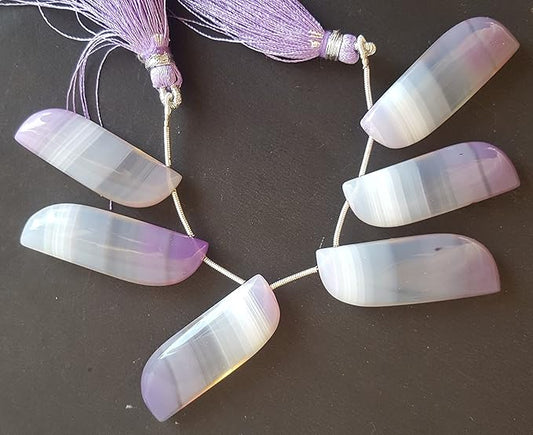 Strand featuring purple shaded chalcedony smooth gemstones, in a stunning purple hue.
