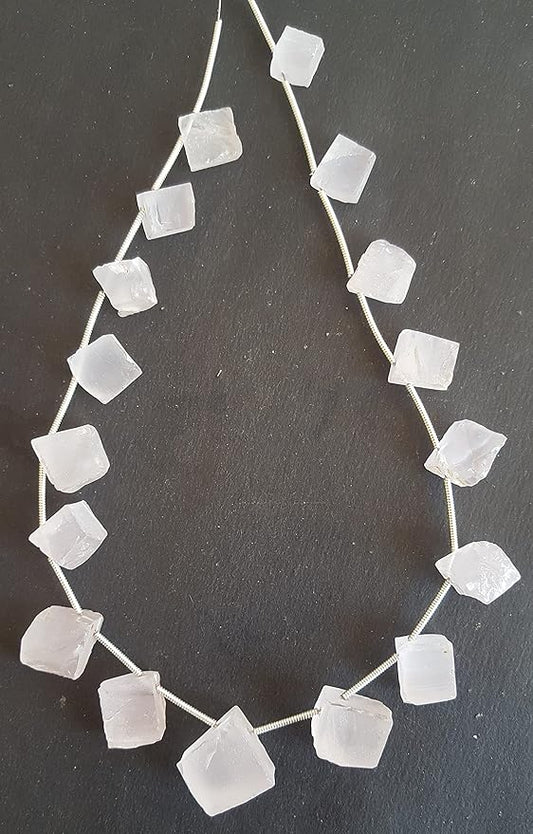 A strand of Rose Quartz beads, rough and side drilled, measuring 10mm to 12mm in size.