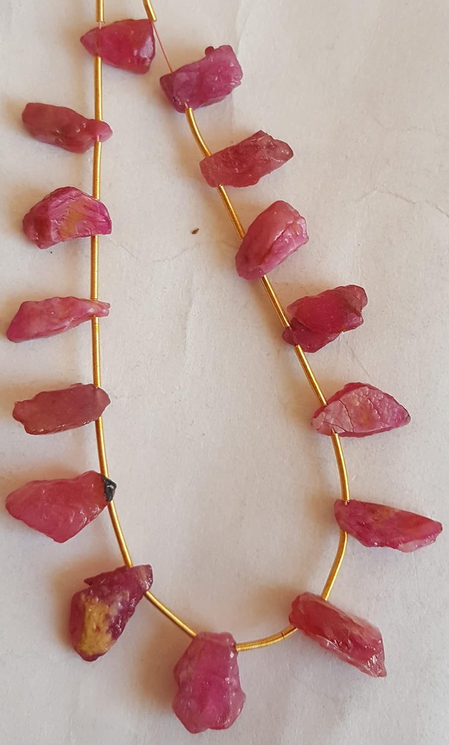 A strand crafted from rough natural ruby gemstone, with beads sized between 6mm and 7mm, radiating warmth and elegance.