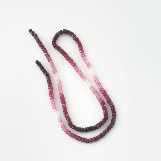 Macro view of 3.4mm Ruby beads showing shaded red to pink gradient