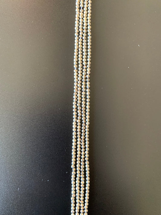 A long strand of sliver pyrite faceted rondelle beads, showcasing their natural beauty and unique colours.