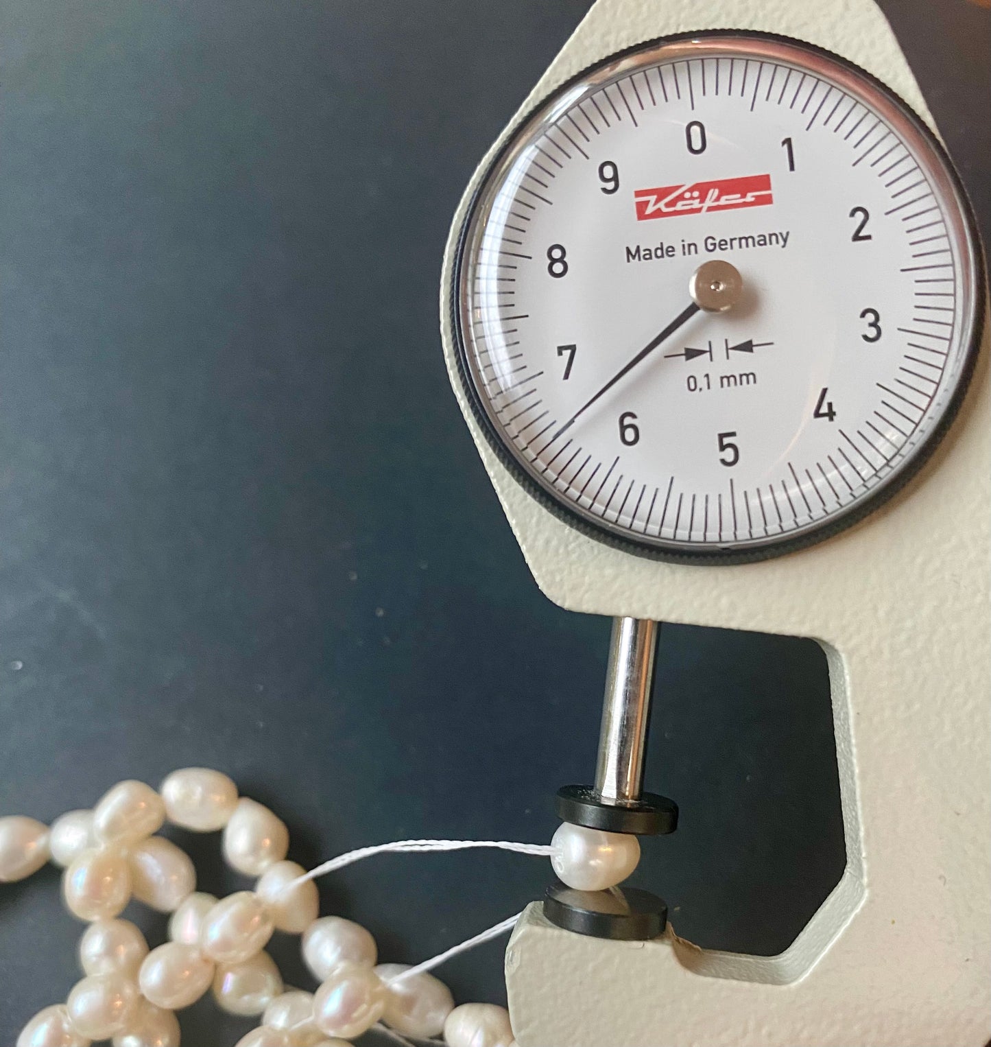 A dial gauge measures the Smooth Baroque Freshwater Pearls 6.5mm.