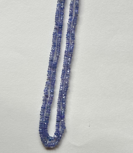 Beautiful strands of semi-precious Tanzanite gemstone beads, featuring faceted rondelles sized between 2.4mm and 3mm, radiating elegance.
