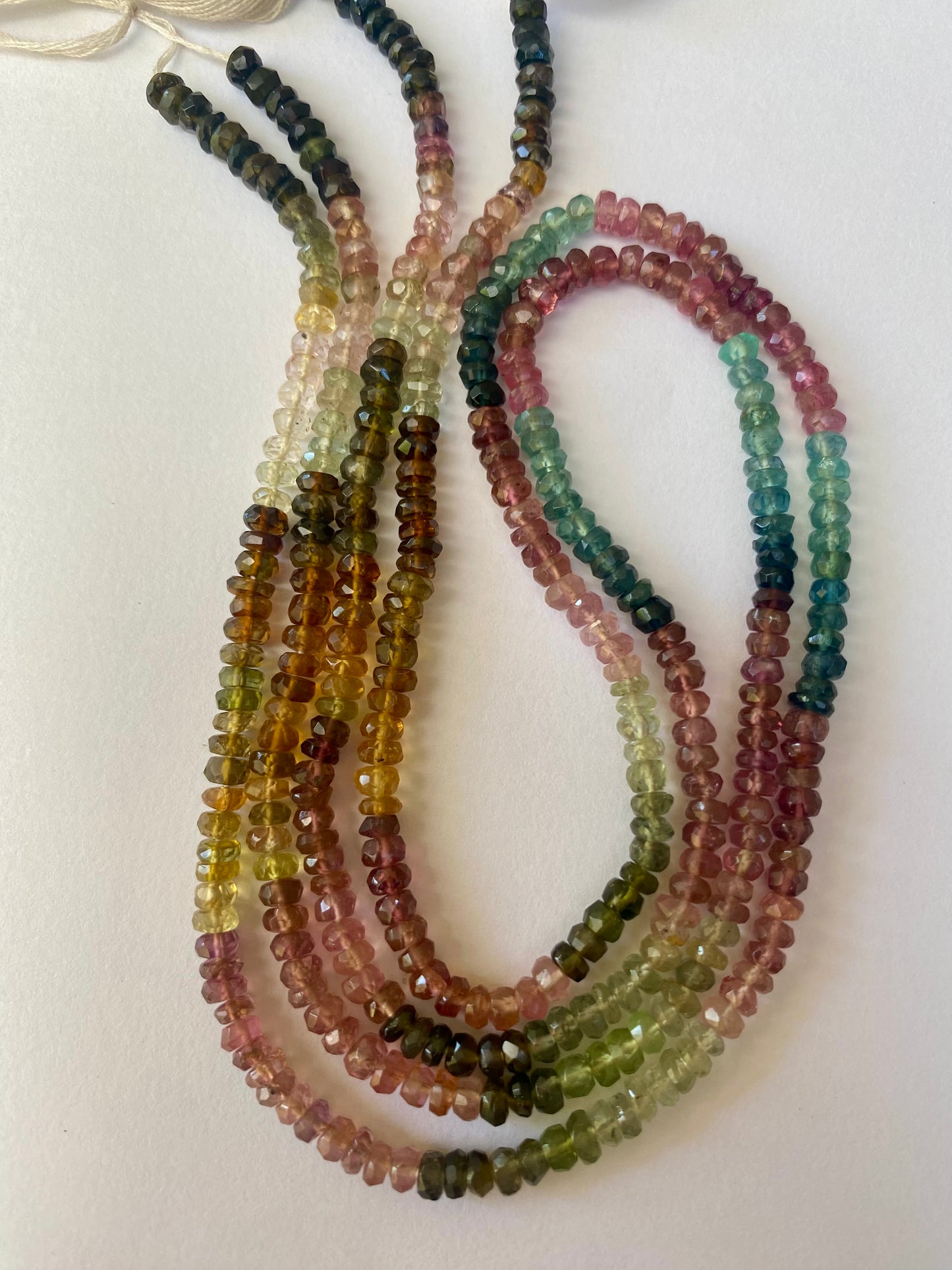 Strand of multi-coloured tourmaline beads, each measuring 3.5-3.9mm in diameter, showcasing a vibrant array of colours.