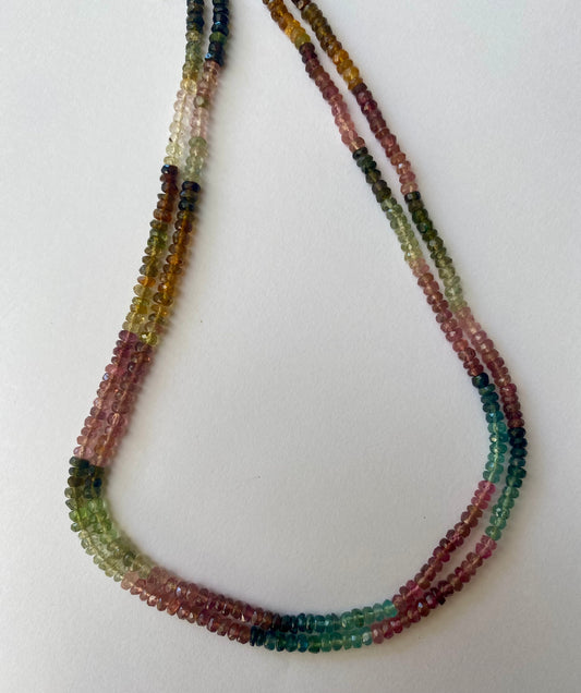 Vibrant strands of multi-coloured tourmaline beads, ranging from 3.5 to 3.9mm in size, displaying a beautiful colour spectrum.