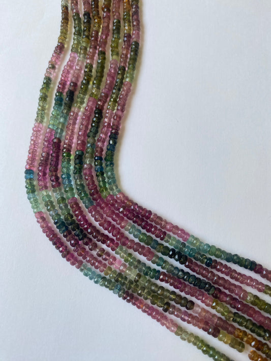 Vibrant rows of 3.5-4mm multicoloured tourmaline beads, displaying a spectrum of hues in a polished finish.