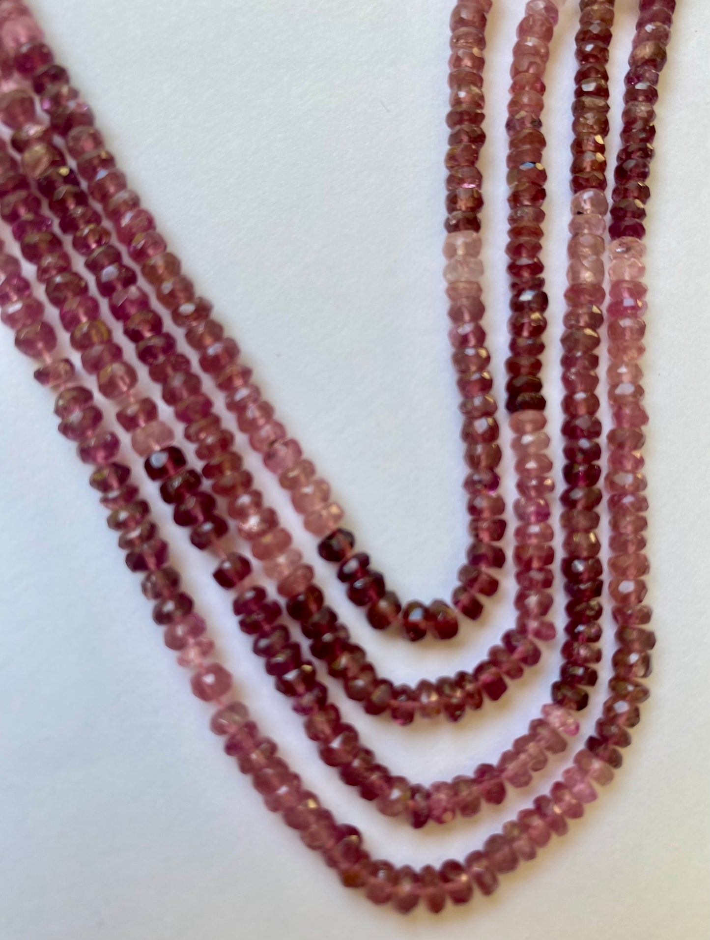 Multi-strand necklace featuring faceted rondelle beads of pink tourmaline, measuring 3.8-4.0mm in size.