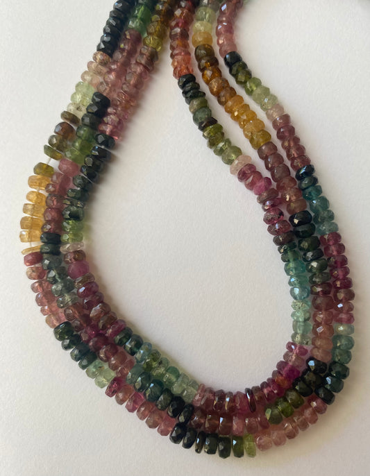 Vibrant strands of faceted rondelle tourmaline beads, showcasing a variety of colours, each bead measuring 4.4-4.8mm.