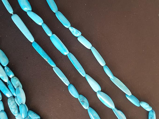 A vibrant assortment of smooth turquoise gemstone beads, measuring 6mm to 8mm, arranged in a group.