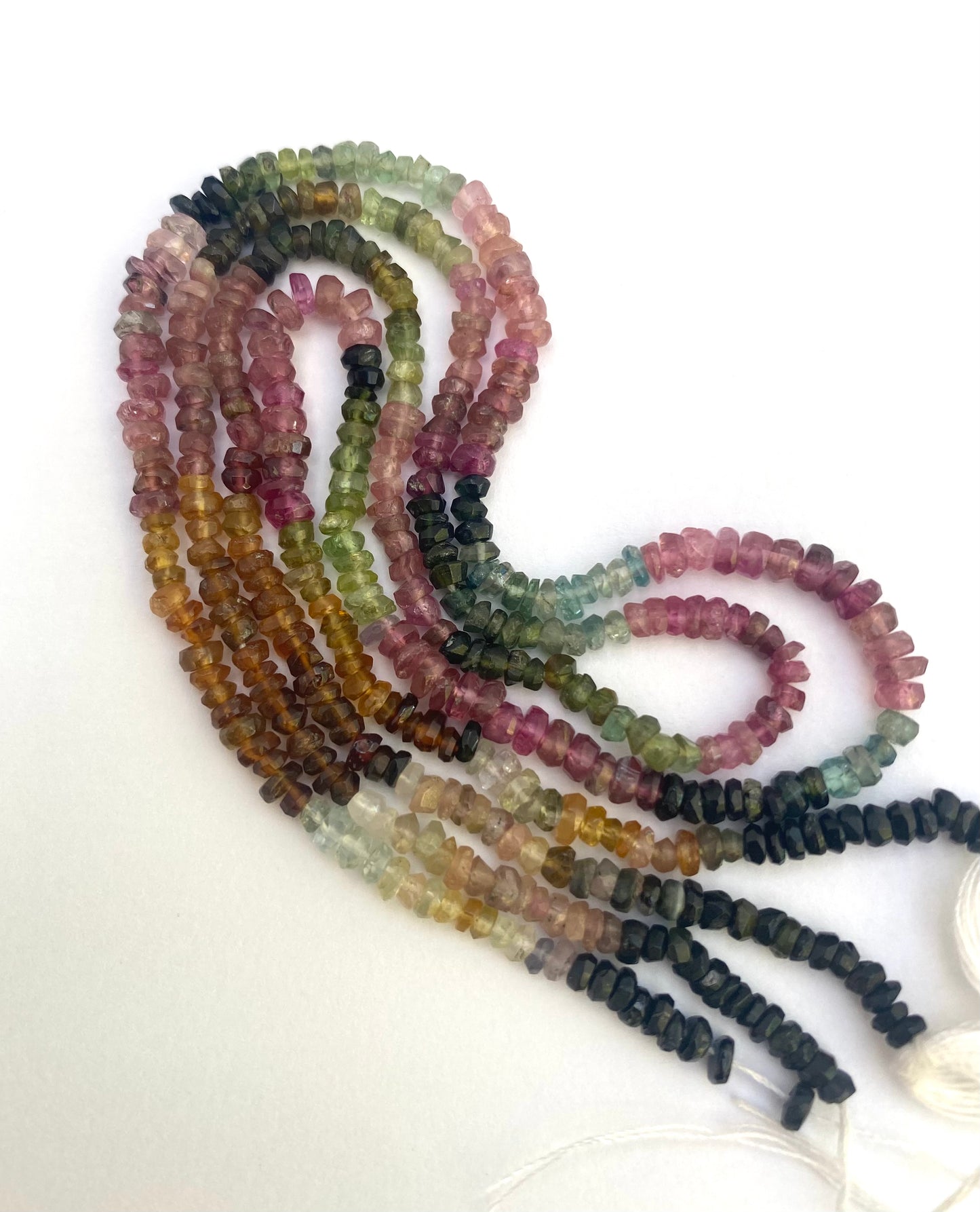 A vibrant strand of faceted watermelon tourmaline beads, showcasing a mix of colours in 3mm rondelle shapes.