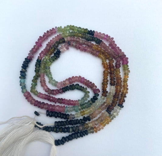 A colourful strand of 3mm faceted rondelle beads made of watermelon tourmaline, displaying a beautiful array of hues.