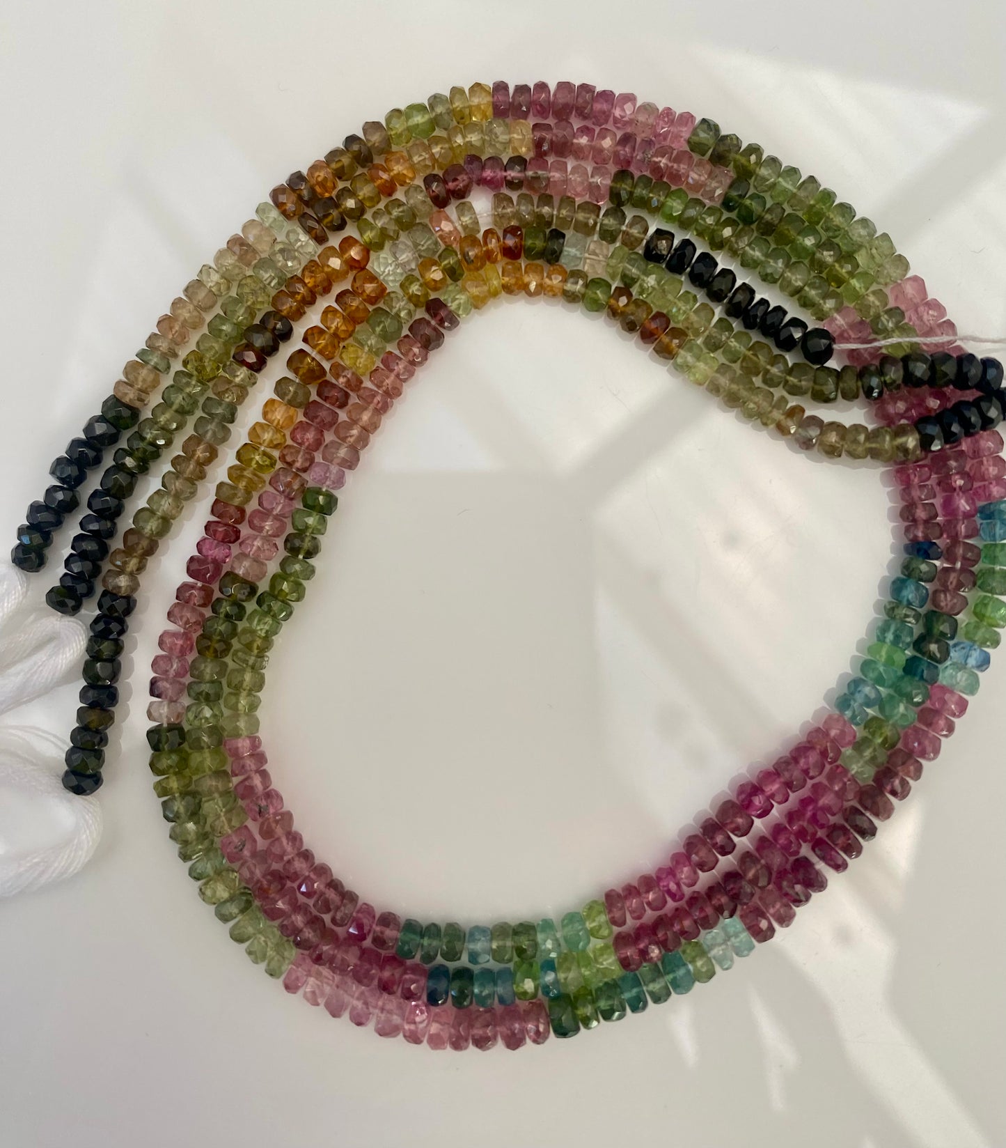 A stunning line of multicoloured micro-cut watermelon tourmaline beads, each 3.4-3.8mm, radiating vibrant colours.